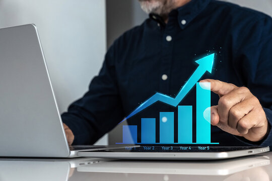 Businessman analyzing a five-year business growth plan with an ascending arrow chart