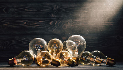 Vintage light bulbs on rustic wood symbolize ideas, innovation, and solutions. Spark creativity in business, education, and personal projects.