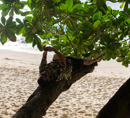 Man laying on tree., nusa penida, bali. High quality photo