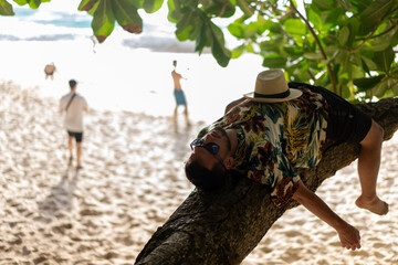 Man laying on tree., nusa penida, bali. High quality photo