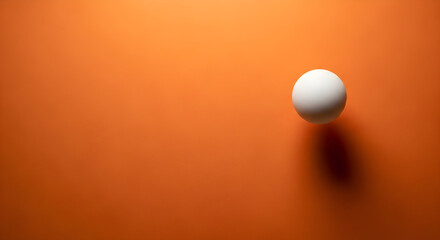 A single white egg casting a shadow on a vibrant orange background.