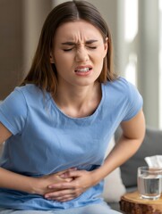 Young Woman Experiencing Stomach Pain and Holding Her Abdomen