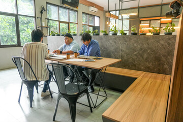 Young Professionals Team Collaborate On Laptops Modern Co Working Space