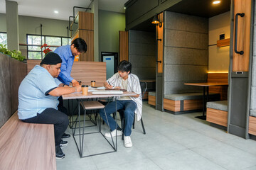 Diverse Young Adults Collaborate And Study Intently In Modern Co Working Space