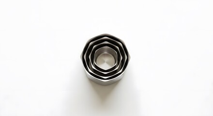 A top down view of nested metal octagon cookie cutters on a white surface in a studio setting