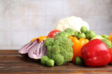 Different fresh raw vegetables on wooden table, closeup. Space for text