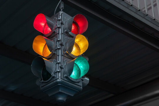 Traffic light under the bridge with red, yellow and green colors. Safety regulations. Traffic light in the city closeup