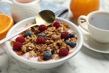 Tasty breakfast. Granola with yogurt and fruits served on white marble table, closeup