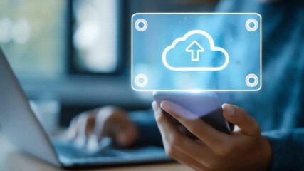 A person using a smartphone to upload files to the cloud, with a laptop in the background. The image represents modern tech, cloud computing, and digital connectivity. - Powered by Adobe
