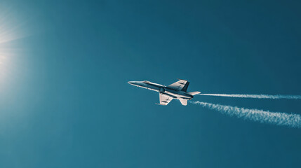 A fighter jet streaks across a clear blue sky, leaving contrails behind it. The aircraft is captured in mid-flight, showcasing its speed and power against a vibrant backdrop