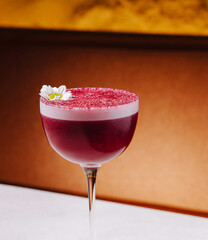 Creative cocktail served in elegant glass with floral garnish