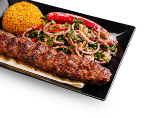 Delicious kebab platter with flavorful sides served on a black plate