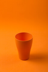 Orange cup on an orange background