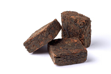Three pieces of pressed fermented black tea isolated on white background.