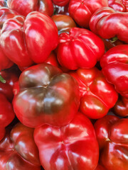 Sweet red bell peppers in store counter. Ripe peppers paprika, natural background. Healthy proper nutrition, diet. Fresh vegetable food. Close-up