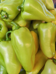 Sweet green bell peppers in store counter. Ripe peppers paprika, natural background. Healthy proper nutrition, diet. Fresh vegetable food. Close-up