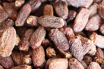 Dates extreme close up showing dense pile of dried fruits with deep wrinkled texture