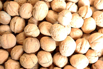 Walnuts extreme close up showing dense pile of raw walnut halves with detailed texture