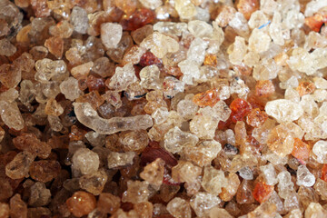Close up of natural gum arabic resin granules with sparkling texture and golden color