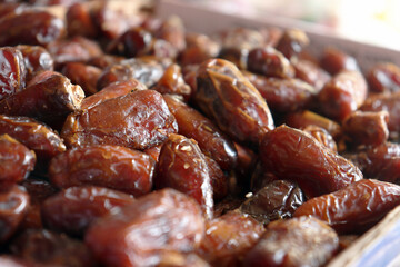 Dates fresh close up highlighting smooth shiny surfaces of tightly packed soft dates