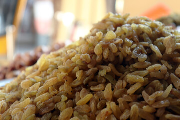 Golden raisins close up showing fresh bright sultanas piled high in a food market