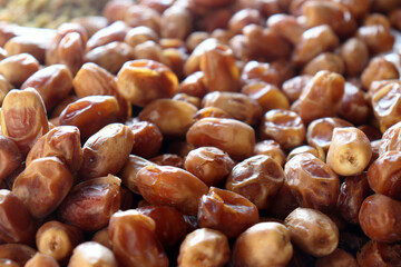 Dates extreme close up showing textured pile of fresh ripe fruit for food backgrounds