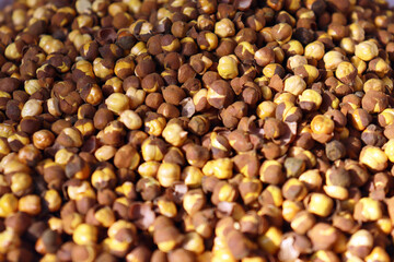 Roasted split chickpeas close up textured food background