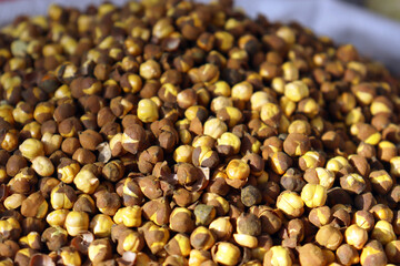 Roasted split chickpeas close up textured food background