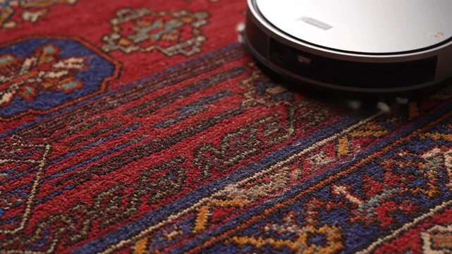 Robot cleaner vacuuming a carpet in the home, housework concept