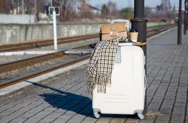 Suitcase and Travel Accessories on Empty Train Platform