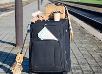 Suitcase and Travel Accessories on Empty Train Platform