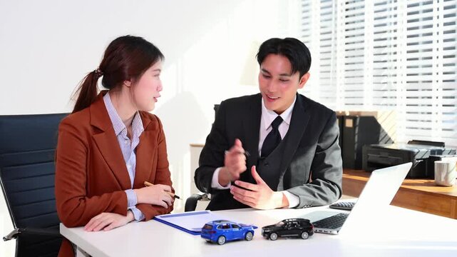 Lawyer and client discussing car insurance claims using vehicle accident models in a modern office.insurance, legal advice, accident claim, and vehicle consultation.