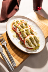 Italian caprese salad with tomatoes, mozarella olive oil and oregano
