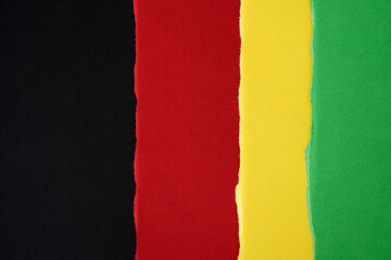 background with a torn paper texture in black, red, yellow, and green