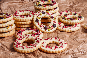 Delicious ring cookies with white icing, dried cranberries, and pistachios