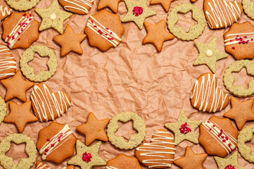 Festive assortment of decorated cookies on a textured brown paper background
