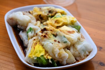 Chinese breakfast or dim sum dish - egg rice roll. Cantonese food in China.