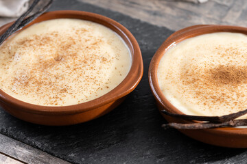 Creamy homemade Spanish custard served in a bowl on wooden table