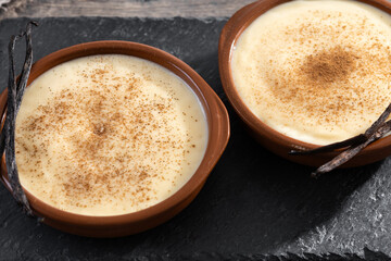 Creamy homemade Spanish custard served in a bowl on wooden table