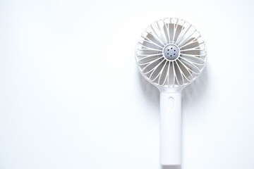 Mini electric fan with handle isolated on white background