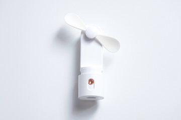 Mini electric fan with handle isolated on white background