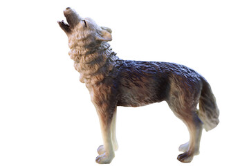 A close-up image of a wolf figurine placed on a plain white background, ideal for use in editorial or commercial contexts