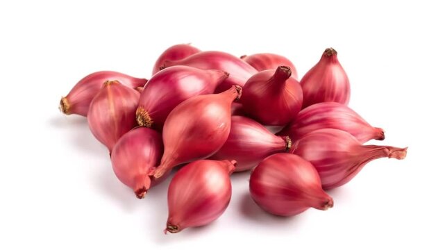Pile of fresh red shallots on white.