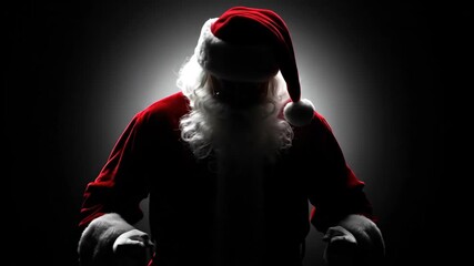 Scary santa claus in dark room. Evil Christmas spirit. Horror holiday. Mysterious man in costume with beard.