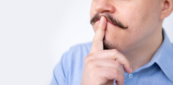 Close up man with mustache touching chin, thinking or making decision, mustached person, Masculine contemplation, doubt and hesitation, Moment reflection, male face detail, decision dilemma
