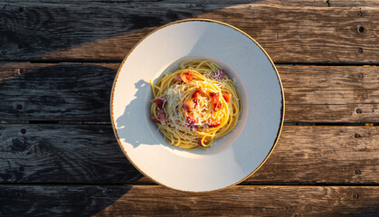 Spaghetti Carbonara on a plate with a wooden background