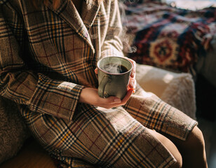 woman with warm plaid and cup of coffee