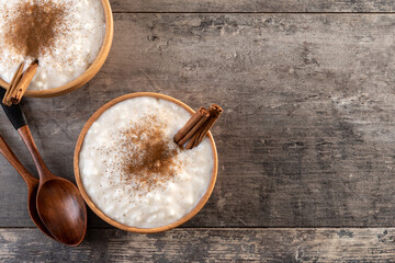 Creamy homemade Spanish custard served in a bowl on wooden table. Top view. Copy space