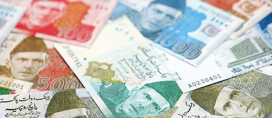 Pakistan rupees banknotes. The current Pakistan money bills lies on table in big amount. The concept of business and investment in Pakistan