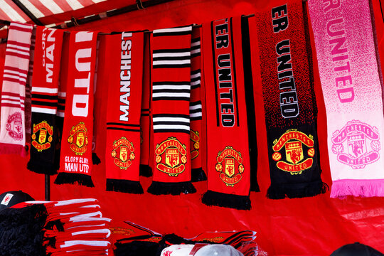 Manchester, England - 17.08.2025: Manchester United scarves hanging on outdoor fan merchandise stall